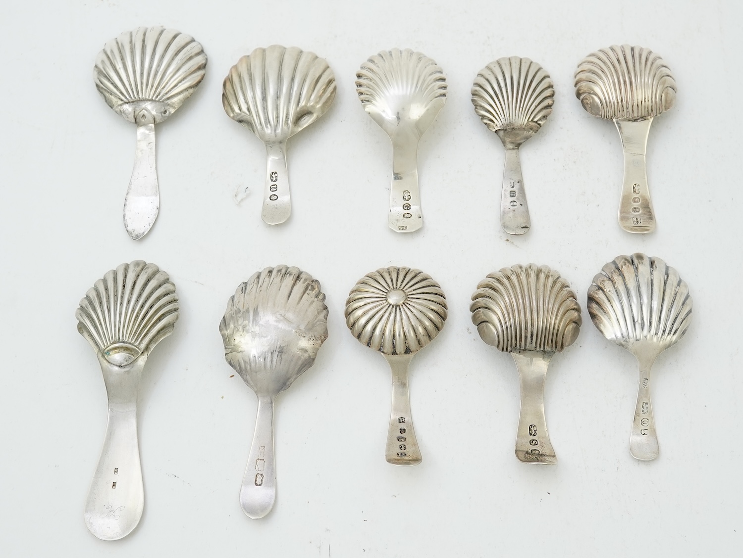 Ten assorted mainly 19th century silver and white metal caddy spoons, with shell or fluted bowls